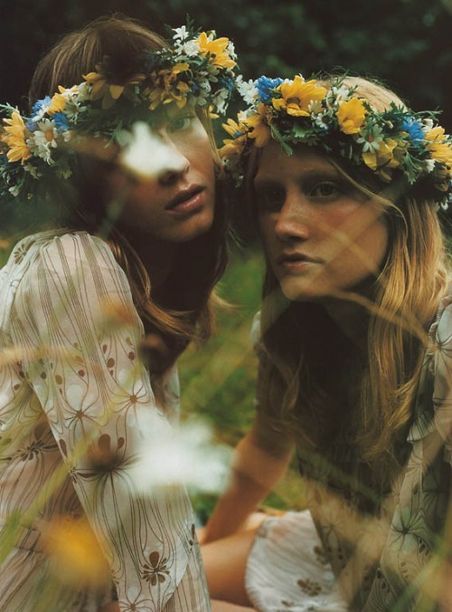 Two girls wearing yellow and green flower crowns