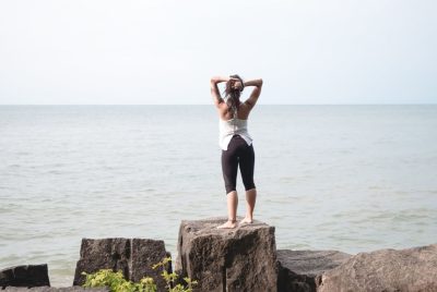 Woman stretching by the ocean
